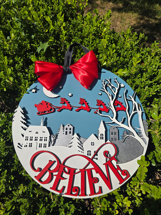 “Believe” Christmas Wall Sign – Santa’s Sleigh Over Winter Town